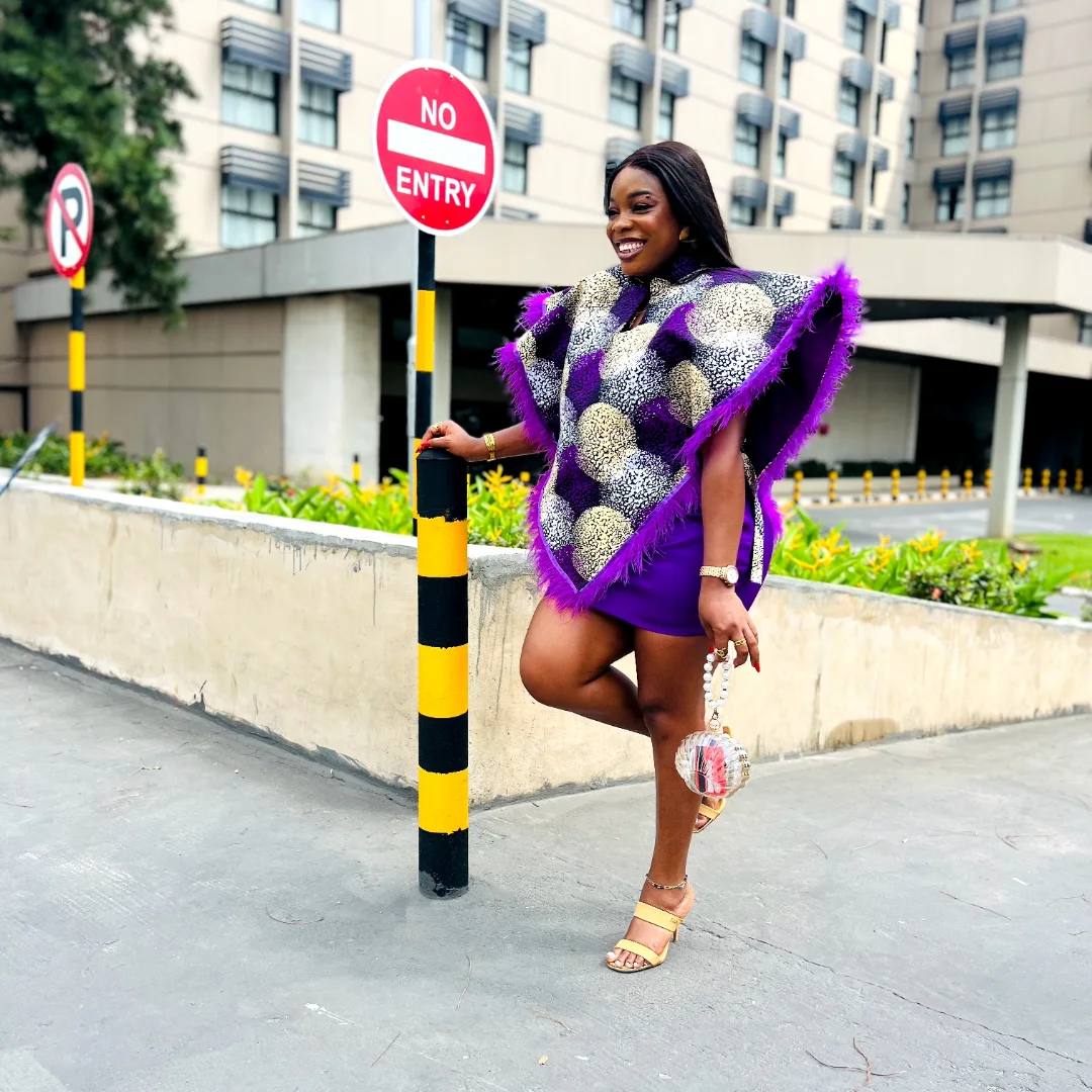 Purple mini with a feather-trim damask cape.