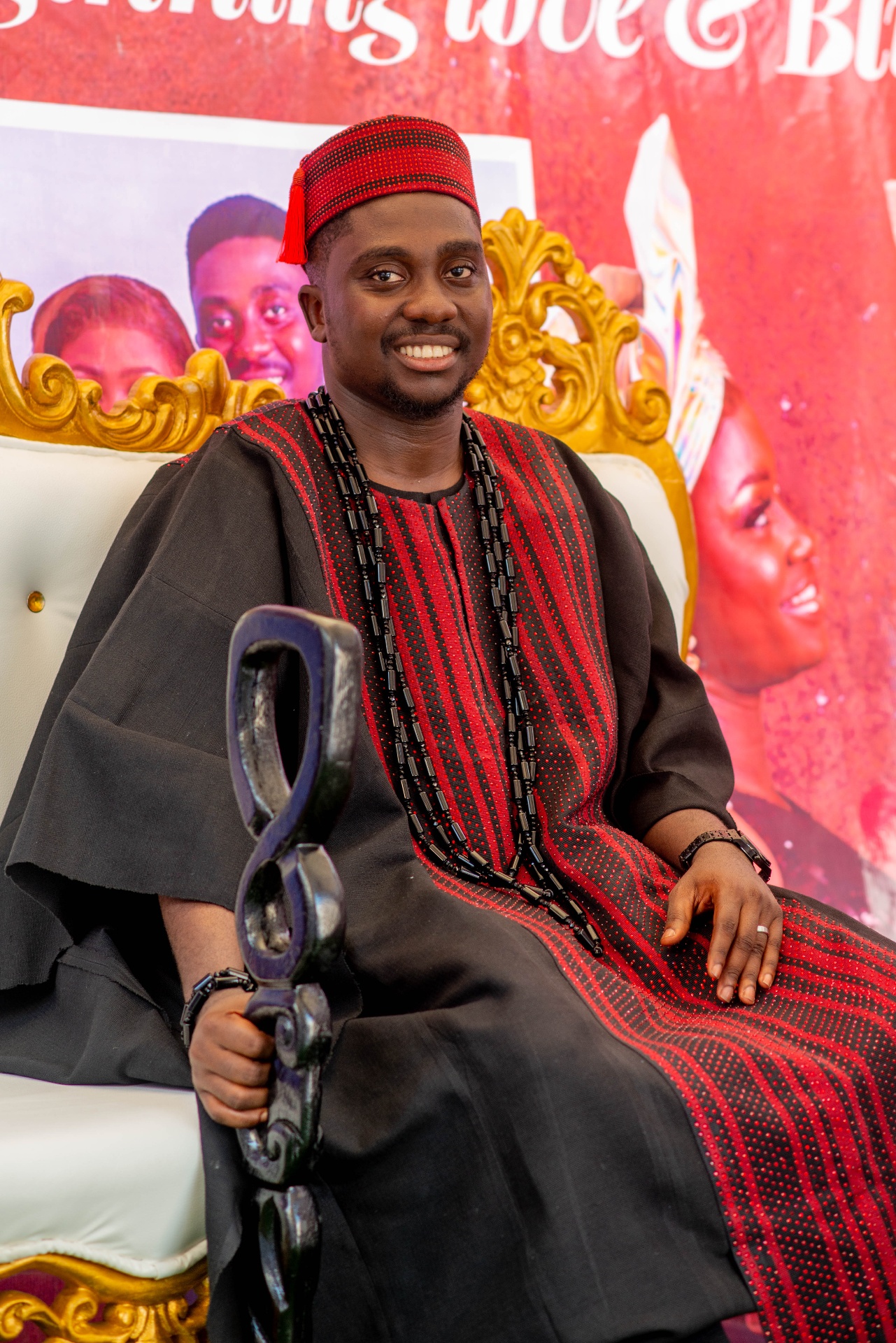 Regal in black & red — traditional Agbada with beaded accents.